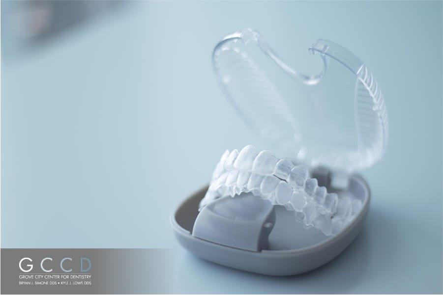 Invisalign clear aligners in an open case on a table