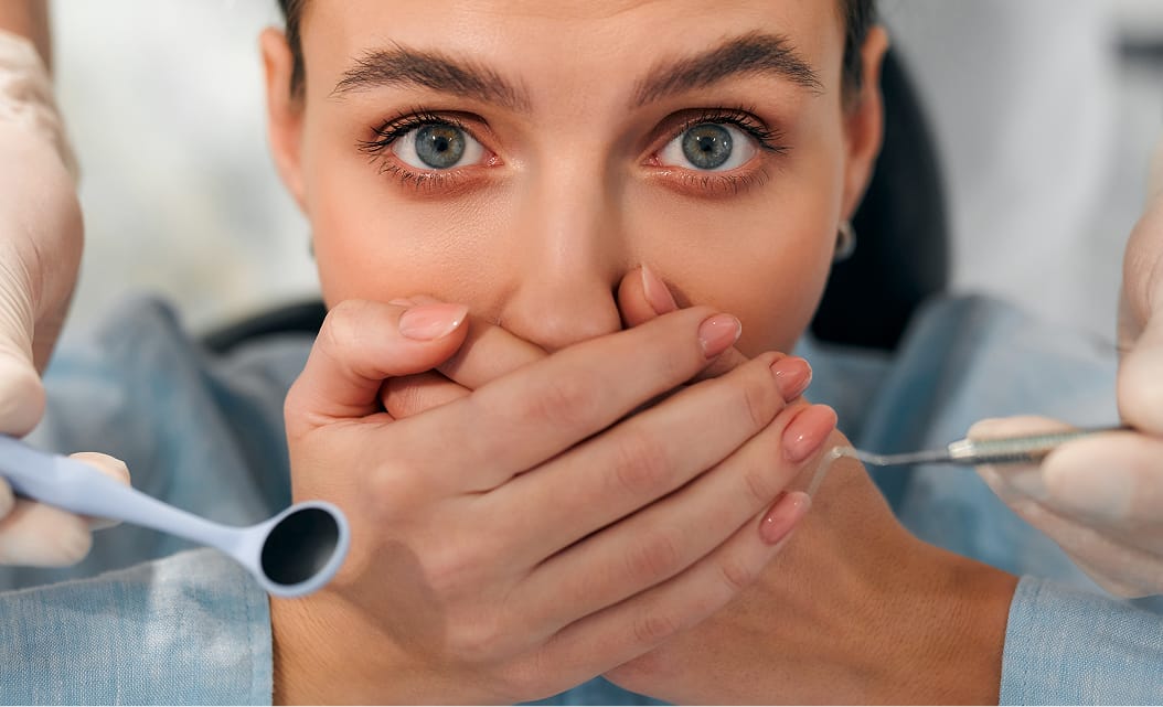 Close-up of a woman covering her mouth with her both hand